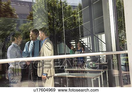 Businessmen shaking hands in office View Large Photo Image Stock Photo - Businessmen shaking hands in office. Fotosearch