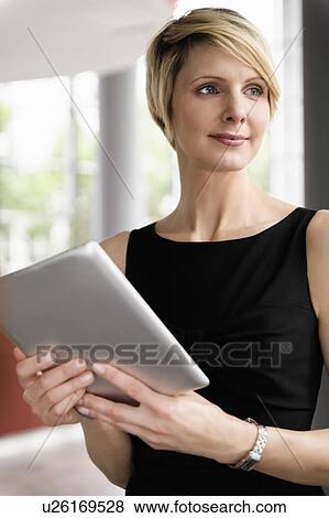 Stock Photo - Businesswoman holding tablet computer. Fotosearch