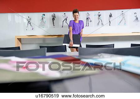 Stock Photo - Businesswoman standing in office. Fotosearch