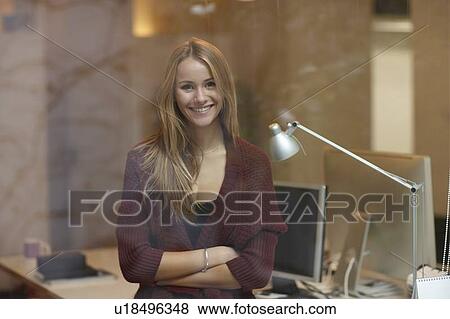 Stock Photo - Businesswoman standing in office. Fotosearch