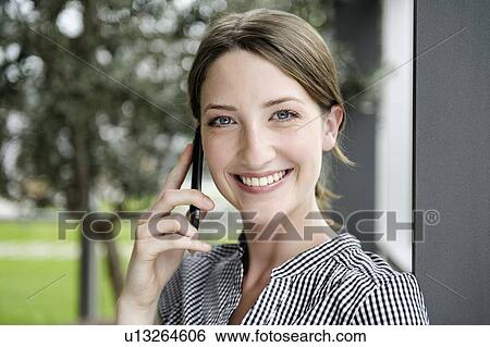 Businesswoman talking on cell phone View Large Photo Image Stock Photograph - Businesswoman talking on cell phone. Fotosearch