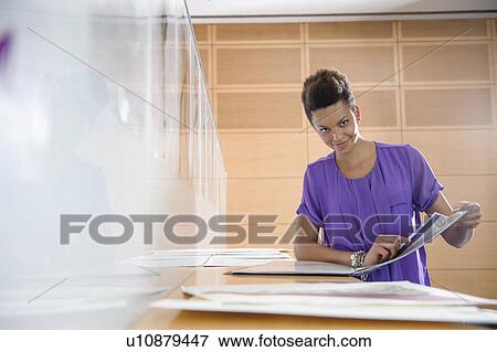 Stock Photo - Businesswoman working in office. Fotosearch