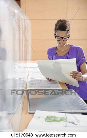 Businesswoman working in office View Large Photo Image Stock Photo - Businesswoman working in office. Fotosearch