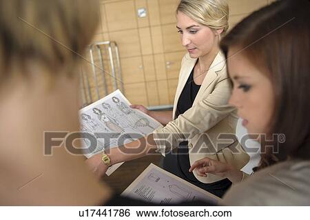 Businesswomen discussing designs View Large Photo Image Stock Photograph - Businesswomen discussing designs. Fotosearch