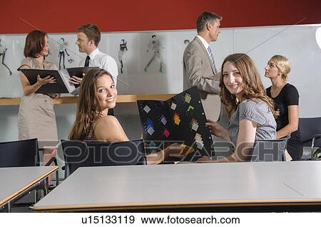 Stock Photo - Businesswomen examining fabric swatches. Fotosearch