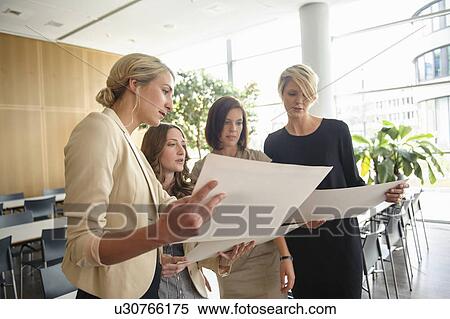 Businesswomen examining papers View Large Photo Image Stock Photography - Businesswomen examining papers. Fotosearch