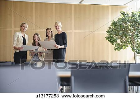 Businesswomen smiling in cafeteria View Large Photo Image Stock Image - Businesswomen smiling in cafeteria. Fotosearch