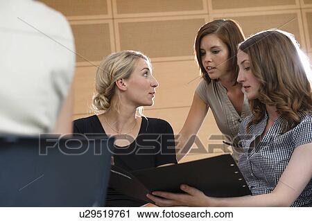 Businesswomen talking in office View Large Photo Image Stock Image - Businesswomen talking in office. Fotosearch