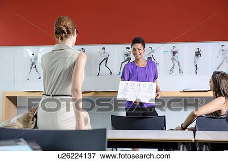 Businesswomen talking in office View Large Photo Image Stock Photo - Businesswomen talking in office. Fotosearch