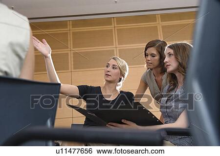 Businesswomen talking in office View Large Photo Image Stock Photograph - Businesswomen talking in office. Fotosearch