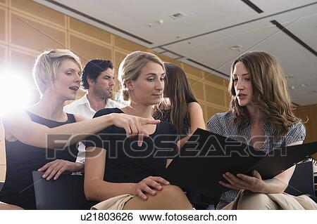 Stock Photograph - Businesswomen talking in office. Fotosearch