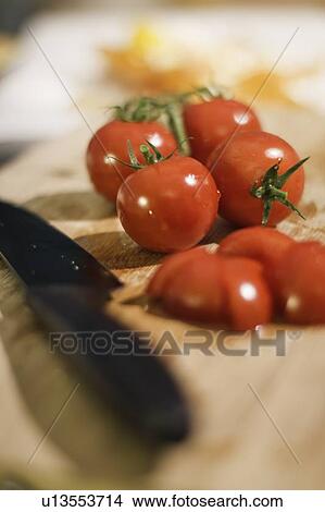 Chopped tomatoes on cutting board View Large Photo Image Picture - Chopped tomatoes on cutting board. Fotosearch