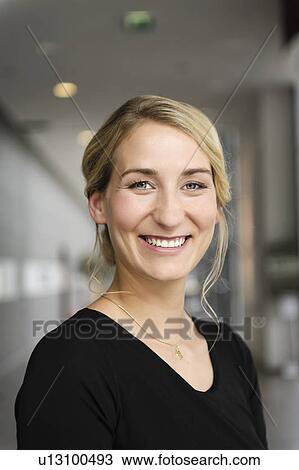 Stock Image - Close up of businesswomans smiling face. Fotosearch
