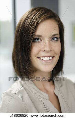 Stock Image - Close up of businesswomans smiling face. Fotosearch