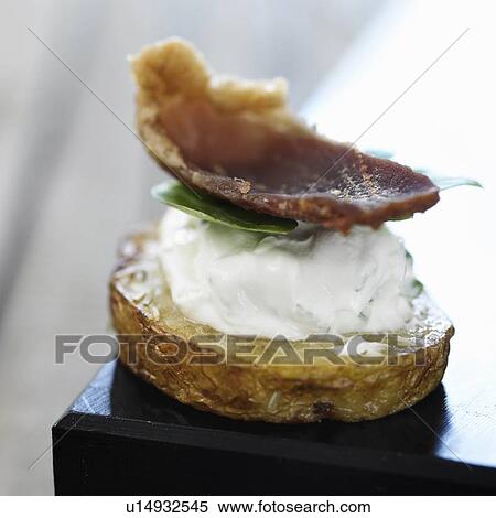 Stock Photography - Close up of cracker with cheese and meat. Fotosearch