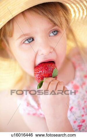 Close up of girl eating strawberry View Large Photo Image Stock Photograph - Close up of girl eating strawberry. Fotosearch