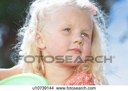 Picture - Close up of girls frowning face. Fotosearch