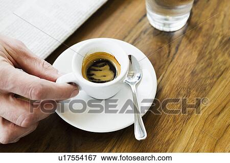 Stock Photo - Close up of hands holding cappuccino. Fotosearch