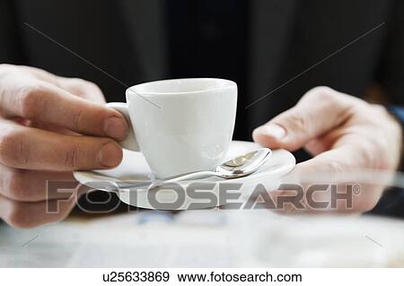 Close up of hands holding cappuccino View Large Photo Image Stock Photo - Close up of hands holding cappuccino. Fotosearch