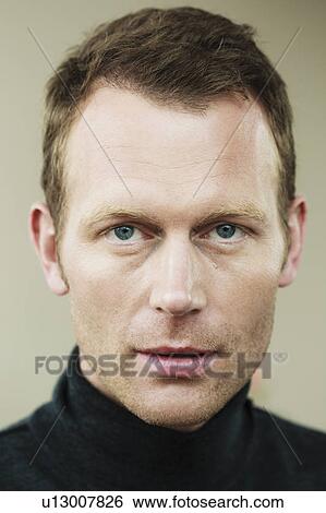 Stock Photograph - Close up of mans serious face. Fotosearch