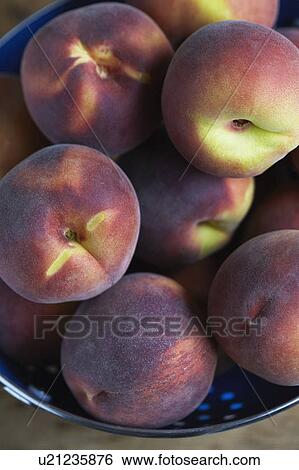 Stock Photograph - Close up of peaches in colander. Fotosearch