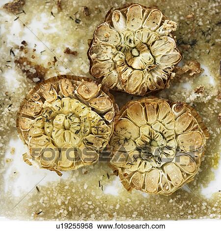 Stock Photo - Close up of roasted garlic bulbs. Fotosearch