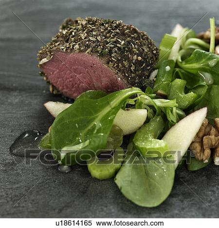 Stock Photography - Close up of salad and roasted meat. Fotosearch
