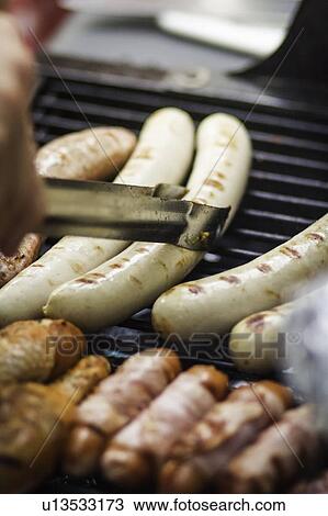 Close up of sausages cooking on grill View Large Photo Image Stock Image - Close up of sausages cooking on grill. Fotosearch