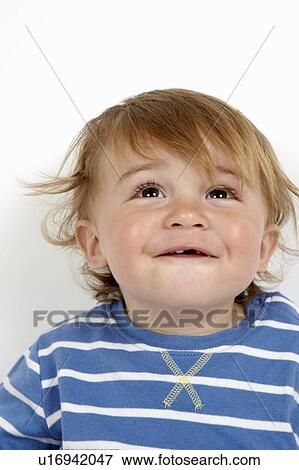 Stock Photo - Close up of toddler boys curious face. Fotosearch