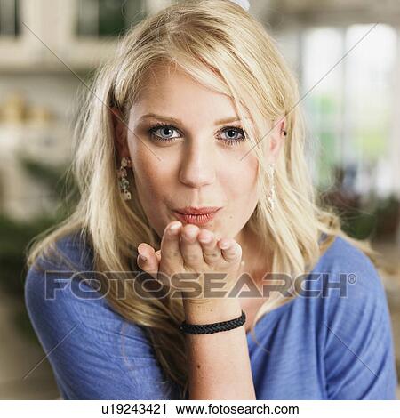Close up of woman blowing a kiss View Large Photo Image Stock Image - Close up of woman blowing a kiss. Fotosearch