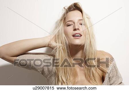 Stock Photography - Close up of woman playing with her hair. Fotosearch