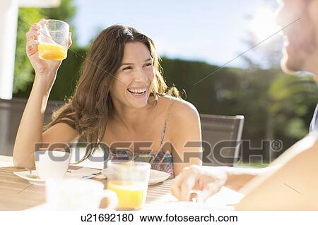 Couple having breakfast outdoors View Large Photo Image Stock Image - Couple having breakfast outdoors. Fotosearch