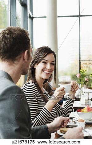 Couple having breakfast together? in caf View Large Photo Image Stock Photography - Couple having breakfast together? in caf. Fotosearch