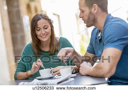 Couple having coffee at sidewalk cafe View Large Photo Image Stock Image - Couple having coffee at sidewalk cafe. Fotosearch