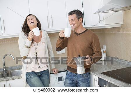 Couple having coffee in kitchen View Large Photo Image Stock Image - Couple having coffee in kitchen. Fotosearch