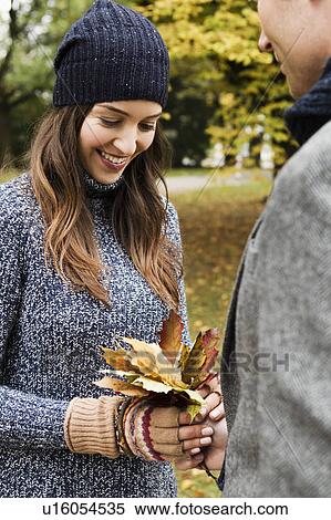 Couple holding autumn leaves View Large Photo Image Stock Photography - Couple holding autumn leaves. Fotosearch