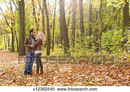 Couple hugging in forest View Large Photo Image Stock Photography - Couple hugging in forest. Fotosearch