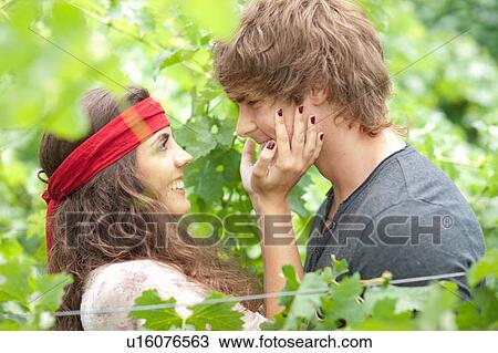 Couple hugging in tall plants View Large Photo Image Stock Image - Couple hugging in tall plants. Fotosearch