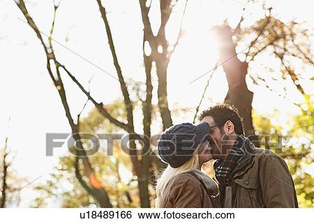 Stock Photograph - Couple kissing in forest. Fotosearch