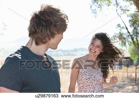 Couple laughing together outdoors View Large Photo Image Stock Image - Couple laughing together outdoors. Fotosearch