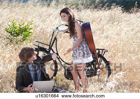 Couple meeting in tall grass View Large Photo Image Picture - Couple meeting in tall grass. Fotosearch
