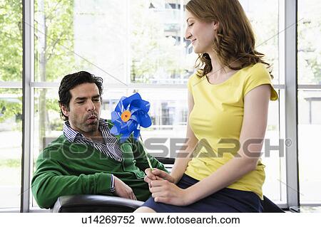 Couple playing with pinwheel View Large Photo Image Stock Image - Couple playing with pinwheel. Fotosearch