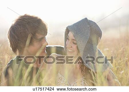 Picture - Couple relaxing in tall grass. Fotosearch