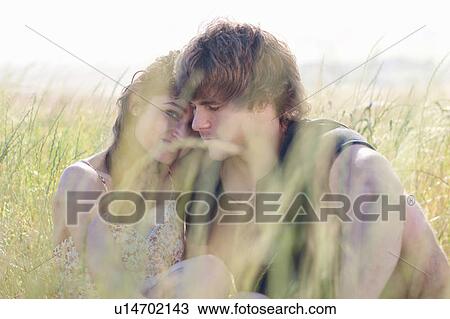 Couple relaxing in tall grass View Large Photo Image Stock Image - Couple relaxing in tall grass. Fotosearch