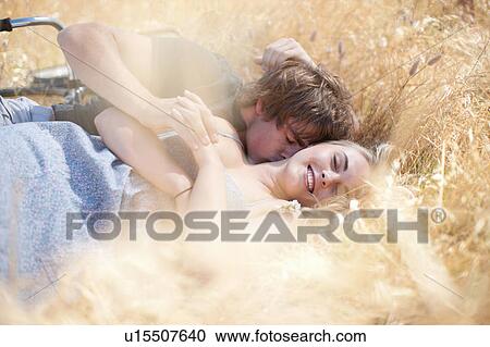 Couple relaxing in tall grass View Large Photo Image Stock Image - Couple relaxing in tall grass. Fotosearch