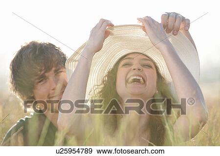 Couple relaxing in tall grass View Large Photo Image Stock Photo - Couple relaxing in tall grass. Fotosearch