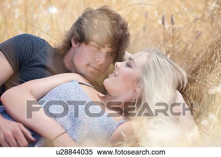Couple relaxing in tall grass View Large Photo Image Stock Photography - Couple relaxing in tall grass. Fotosearch