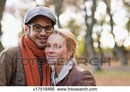 Stock Photograph - Couple standing together in forest. Fotosearch