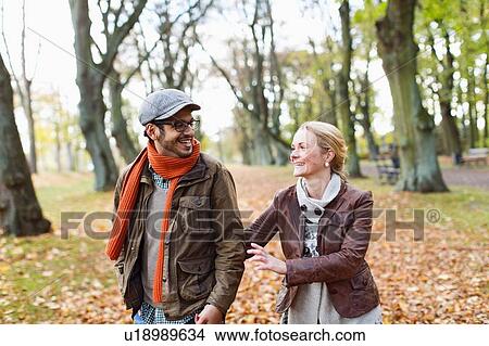 Couple walking together in forest View Large Photo Image Picture - Couple walking together in forest. Fotosearch