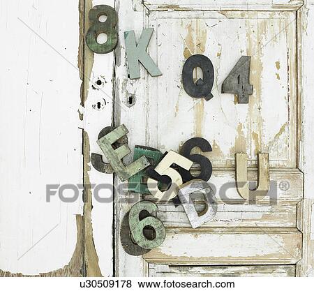 Stock Photo - Decorative wooden symbols on door. Fotosearch